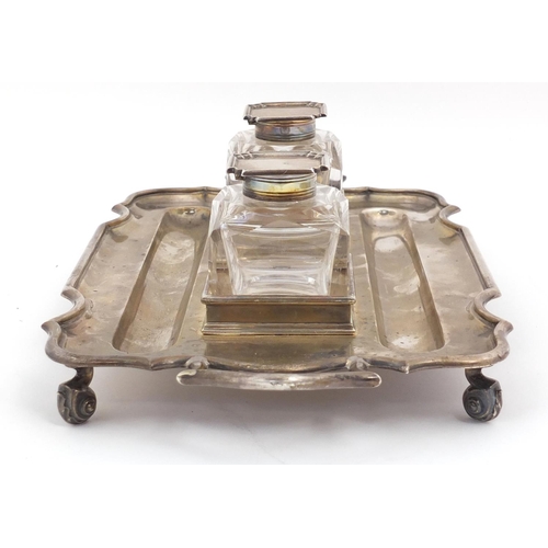 3059 - Thomas Bradbury & Sons, Edward VII silver desk stand  with a pair of heavy cut glass inkwells, raise... 