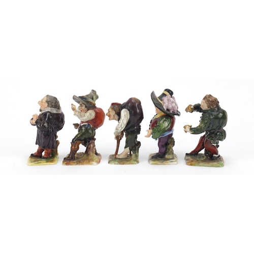 493 - Five 19th century Continental porcelain dwarfs, factory marks to the bases, the largest 9cm high