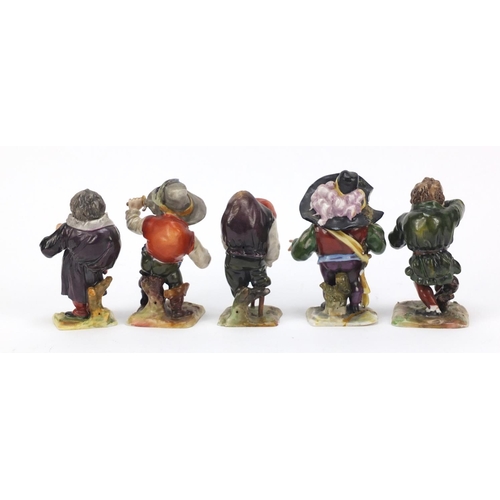 493 - Five 19th century Continental porcelain dwarfs, factory marks to the bases, the largest 9cm high