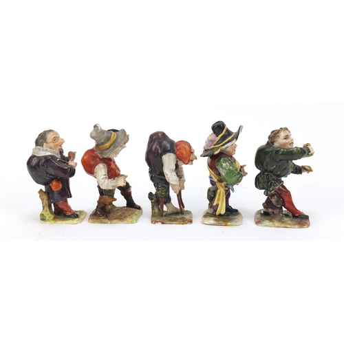 493 - Five 19th century Continental porcelain dwarfs, factory marks to the bases, the largest 9cm high