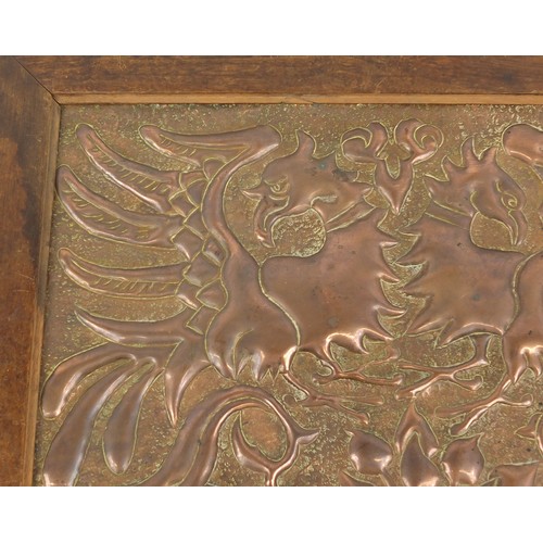 1537 - Arts and crafts oak side table inset with a copper panel decorated with mythical griffins around a t... 