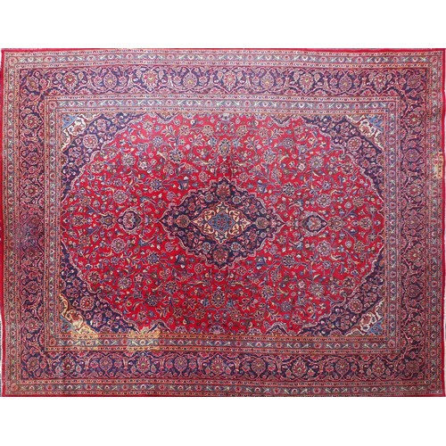 1509 - Rectangular Persian Kashan carpet with floral pattern onto a red and blue ground, 377cm x 295cm