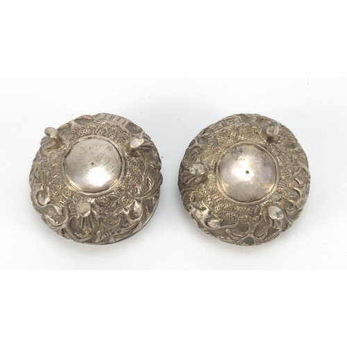 3078 - Pair of Burmese silver coloured metal open salts, embossed with animals and trees, 5cm in diameter, ... 