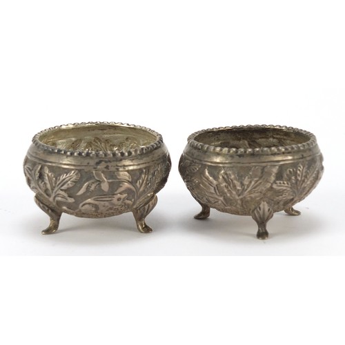 3078 - Pair of Burmese silver coloured metal open salts, embossed with animals and trees, 5cm in diameter, ... 