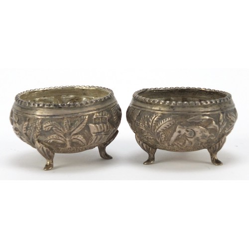 3078 - Pair of Burmese silver coloured metal open salts, embossed with animals and trees, 5cm in diameter, ... 