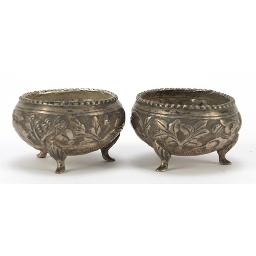 3078 - Pair of Burmese silver coloured metal open salts, embossed with animals and trees, 5cm in diameter, ... 