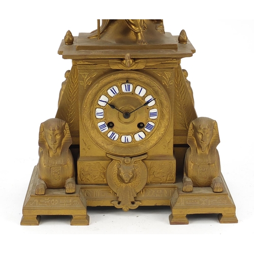 13 - French gilt metal Egyptian Revival mantle clock striking on a bell surmounted with a female and two ... 
