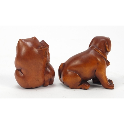 230 - Two Japanese boxwood Netsukes including one of two dogs, the largest 4cm high