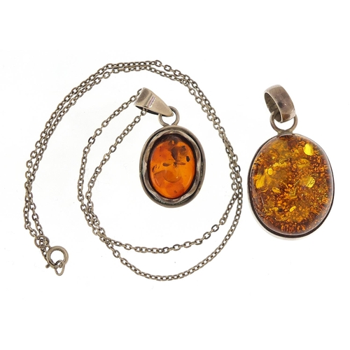 2216 - Two silver and amber pendants, one with silver necklace, the largest pendant 4.5cm high, total 19.5g