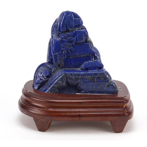 2179 - Chinese lapis lazuli landscape carving raised on a wood base, 16cm high