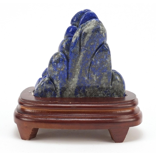 2179 - Chinese lapis lazuli landscape carving raised on a wood base, 16cm high