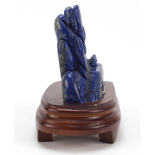 2179 - Chinese lapis lazuli landscape carving raised on a wood base, 16cm high