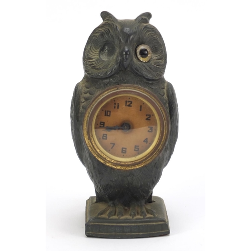 74 - Patinated spelter owl design desk clock with circular dial having Arabic numerals, 17cm high