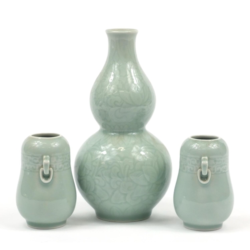 224 - Three Chinese celadon glaze vases comprising a pair and double gourd example incised with flowers, t... 