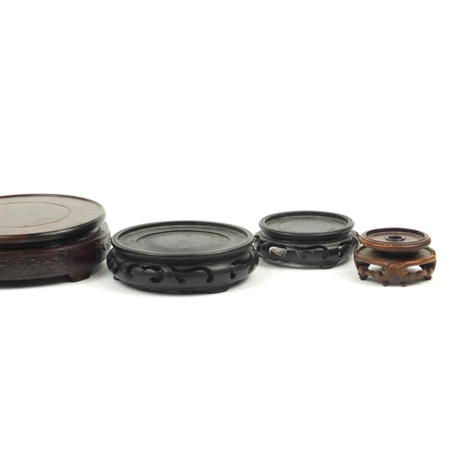 167 - Seven Chinese carved hardwood stands including two pairs, the largest 16cm in diameter