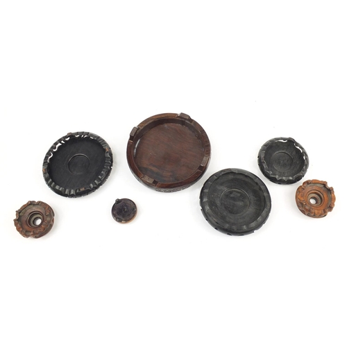 167 - Seven Chinese carved hardwood stands including two pairs, the largest 16cm in diameter