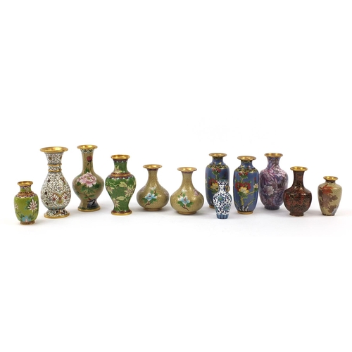 2182 - Twelve Chinese cloisonné vases, each enamelled with flowers including two pairs within ruyi head bor... 