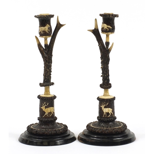 10 - H F C Rampendahl, Pair of 19th century antler horn and bone candlesticks carved with stags and hunti... 