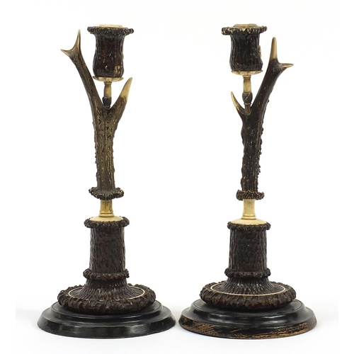 10 - H F C Rampendahl, Pair of 19th century antler horn and bone candlesticks carved with stags and hunti... 