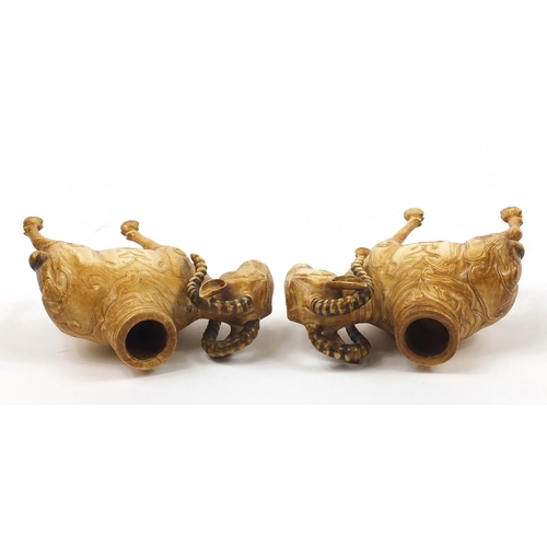 12 - Pair of 19th century European ivory goat match holders carved with animals, each 9cm in length