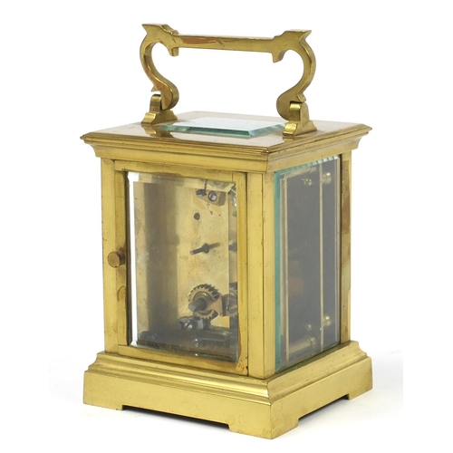 73 - Large brass cased carriage clock with enamel dial having Roman numerals, 12cm high