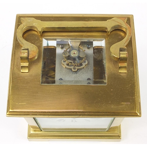 73 - Large brass cased carriage clock with enamel dial having Roman numerals, 12cm high