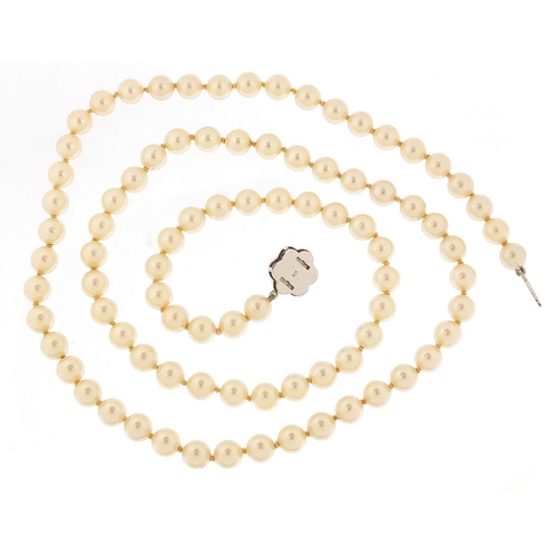 3030 - Simulated pearl necklace with silver clasp housed in a Mikimoto Pearls box, 70cm in length, 48.8g