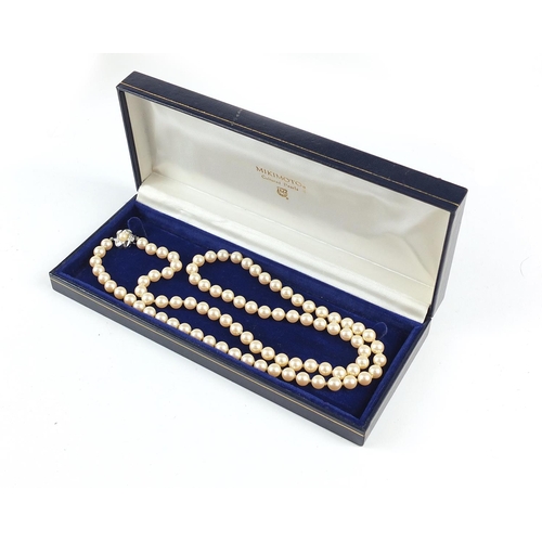 3030 - Simulated pearl necklace with silver clasp housed in a Mikimoto Pearls box, 70cm in length, 48.8g