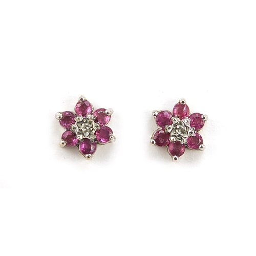 2214 - Pair of 9ct gold ruby and diamond flower head stud earrings, 8mm in diameter, 0.9g