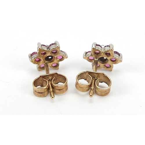 2214 - Pair of 9ct gold ruby and diamond flower head stud earrings, 8mm in diameter, 0.9g