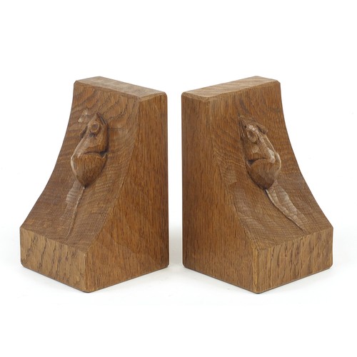 64 - Robert Mouseman Thompson, pair of adzed oak book ends, each carved with a mouse, each 15.5cm high