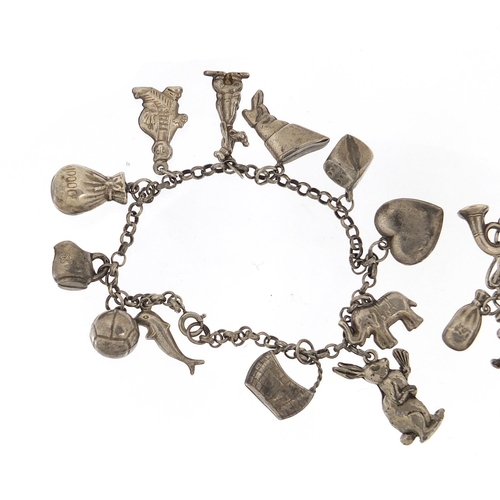 690 - Two silver charm bracelets with a selection of mostly silver charms including tiger, kangaroo, monke... 