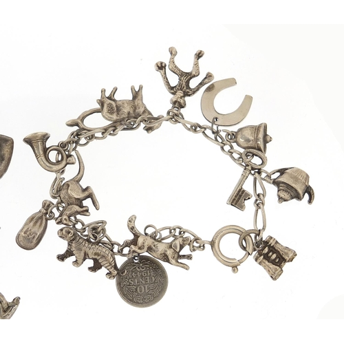 690 - Two silver charm bracelets with a selection of mostly silver charms including tiger, kangaroo, monke... 