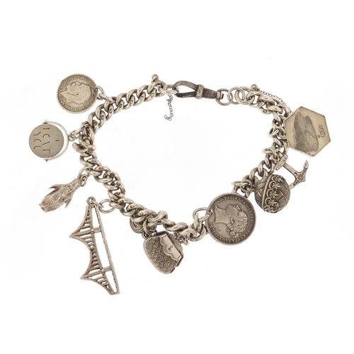 737 - Silver charm bracelet with a selection of mostly silver charms including Severn Road Bridge, anchor,... 