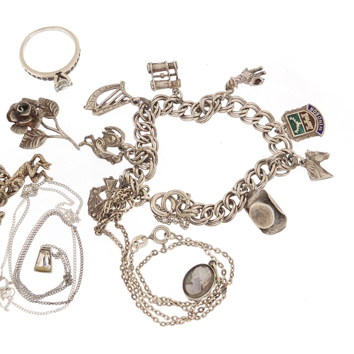 1149 - Silver jewellery including two charm bracelets, cameo pendant and a clear stone ring, 55.0g