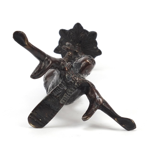 150 - Patinated bronze candlestick in the form of a Chinese acrobat, 25cm high