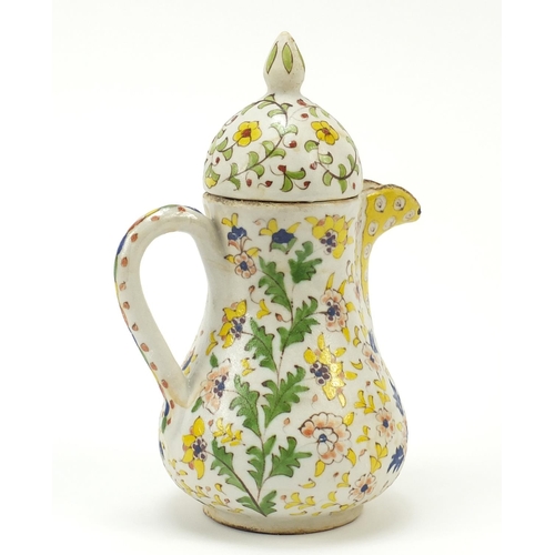 53 - Turkish Kutahya pottery coffee pot hand painted with flowers amongst foliage, 21cm high