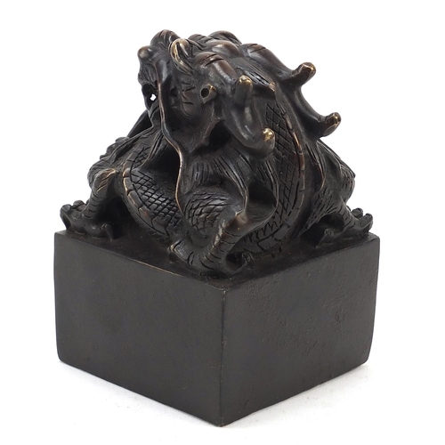 244 - Large Chinese patinated bronze dragon seal, character marks to the base, 13.5cm high