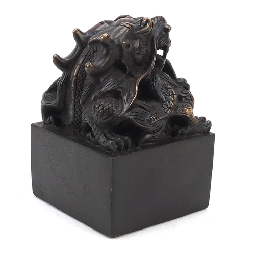 244 - Large Chinese patinated bronze dragon seal, character marks to the base, 13.5cm high