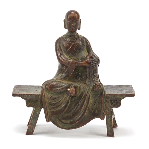 1916 - Chinese bronze monk seated on a bench, 6.5cm wide