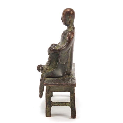 1916 - Chinese bronze monk seated on a bench, 6.5cm wide