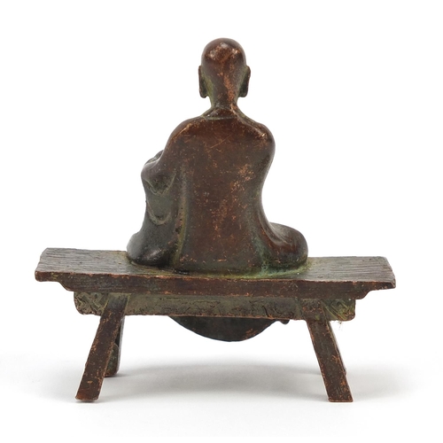 1916 - Chinese bronze monk seated on a bench, 6.5cm wide