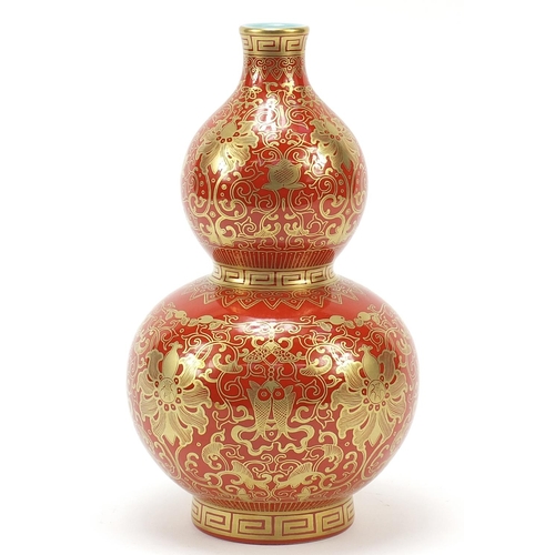 339 - Chinese iron red ground double gourd porcelain vase, finely gilded with flower heads and fish amongs... 