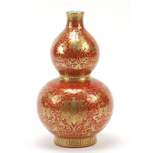 339 - Chinese iron red ground double gourd porcelain vase, finely gilded with flower heads and fish amongs... 