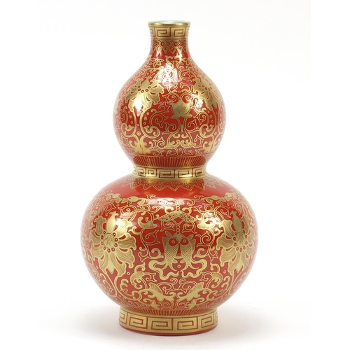 339 - Chinese iron red ground double gourd porcelain vase, finely gilded with flower heads and fish amongs... 