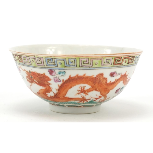 96 - Chinese porcelain bowl hand painted in the famille rose palette with a phoenix and dragon above wave... 