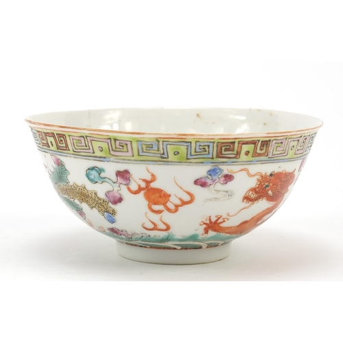 96 - Chinese porcelain bowl hand painted in the famille rose palette with a phoenix and dragon above wave... 