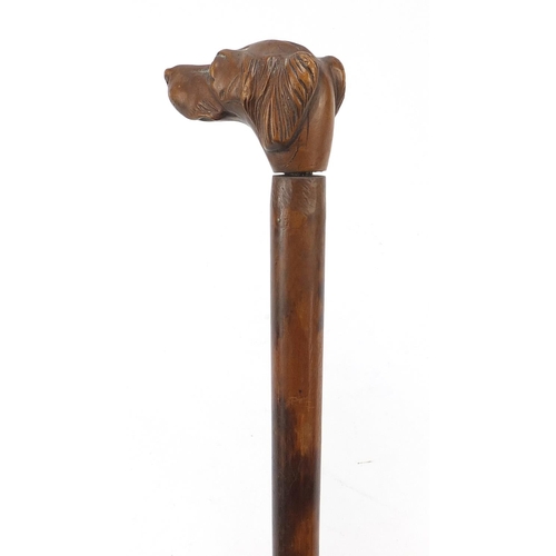 392 - 19th century treen walking stick with carved dog's head design handle, 80cm in length