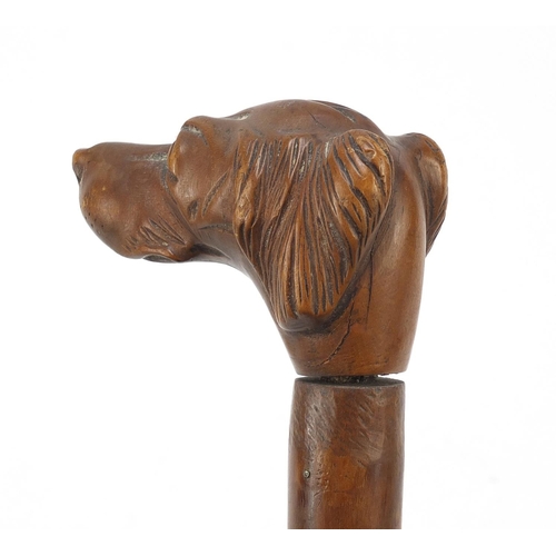 392 - 19th century treen walking stick with carved dog's head design handle, 80cm in length