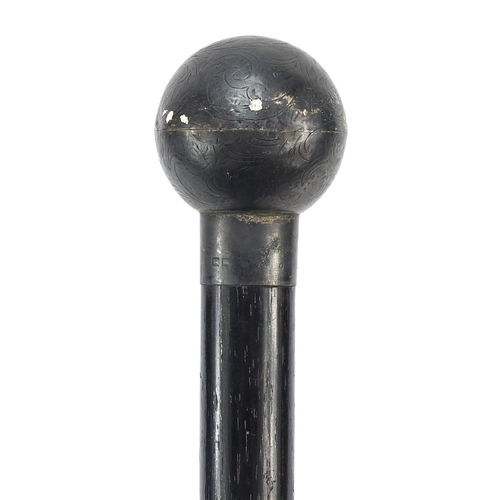 394 - Ebonised walking stick with globular floral chased silver pommel, London 1924, 89cm in length